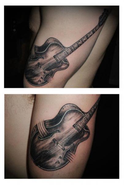 Tatuaje Brazo Realista Guitarra por Rainfire Tattoo