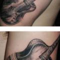 Arm Realistic Guitar tattoo by Rainfire Tattoo