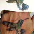 Realistic Hand Hummingbird tattoo by Dingo Tattoo