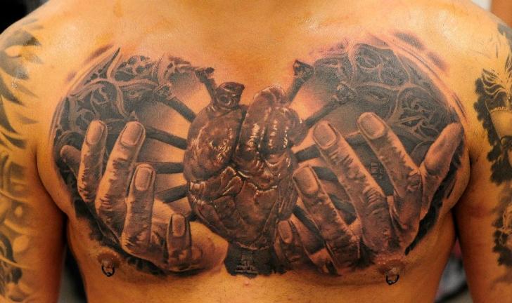 Realistic Chest Heart Hand Tattoo by Radical Ink
