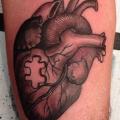 Arm Heart Puzzle tattoo by Camila Rocha