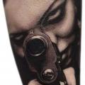 Arm Realistic Women Gun tattoo by Piranha Tattoo Studio