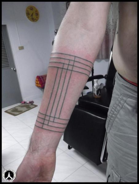 Lexica  trauma in the style of a simple minimalist black and white fine line  tattoo along a male forearm