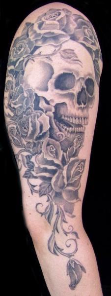 Arm Realistic Skull Flowers Tattoo by Cia Tattoo